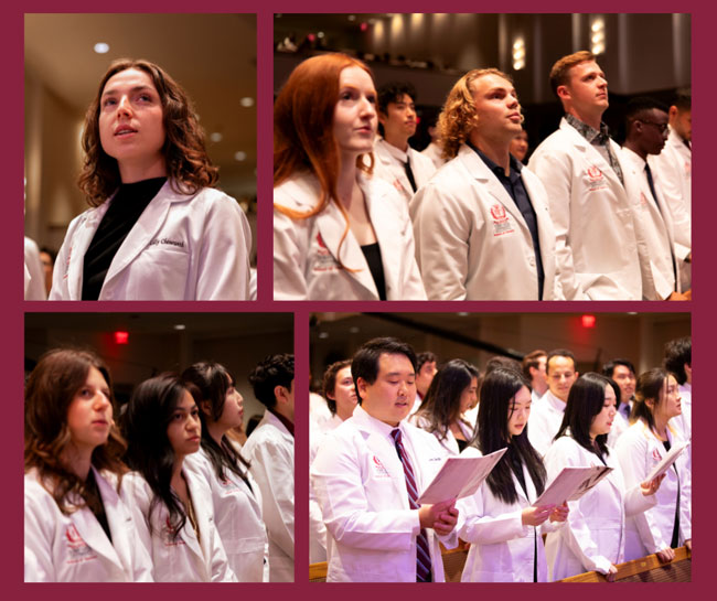 Students wearing white coats participate in a School of Dentistry dedication ceremony, standing together during a formal program