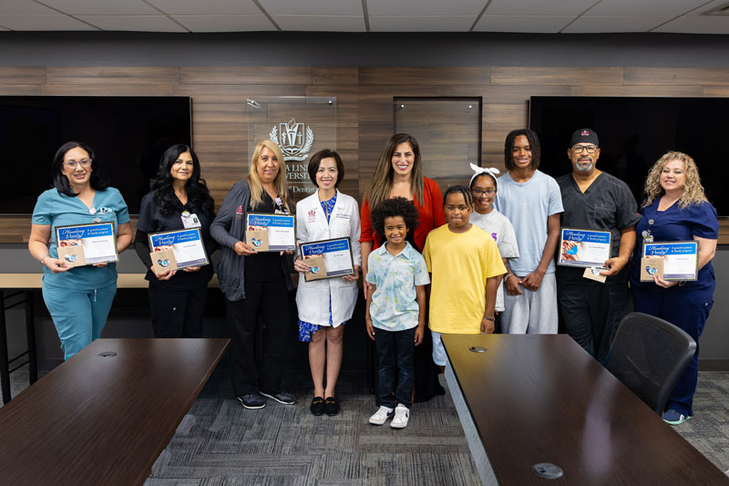Healing Hands Award recipients and Justice's family pose with award certificates during a recognition event hosted by LLUSD.