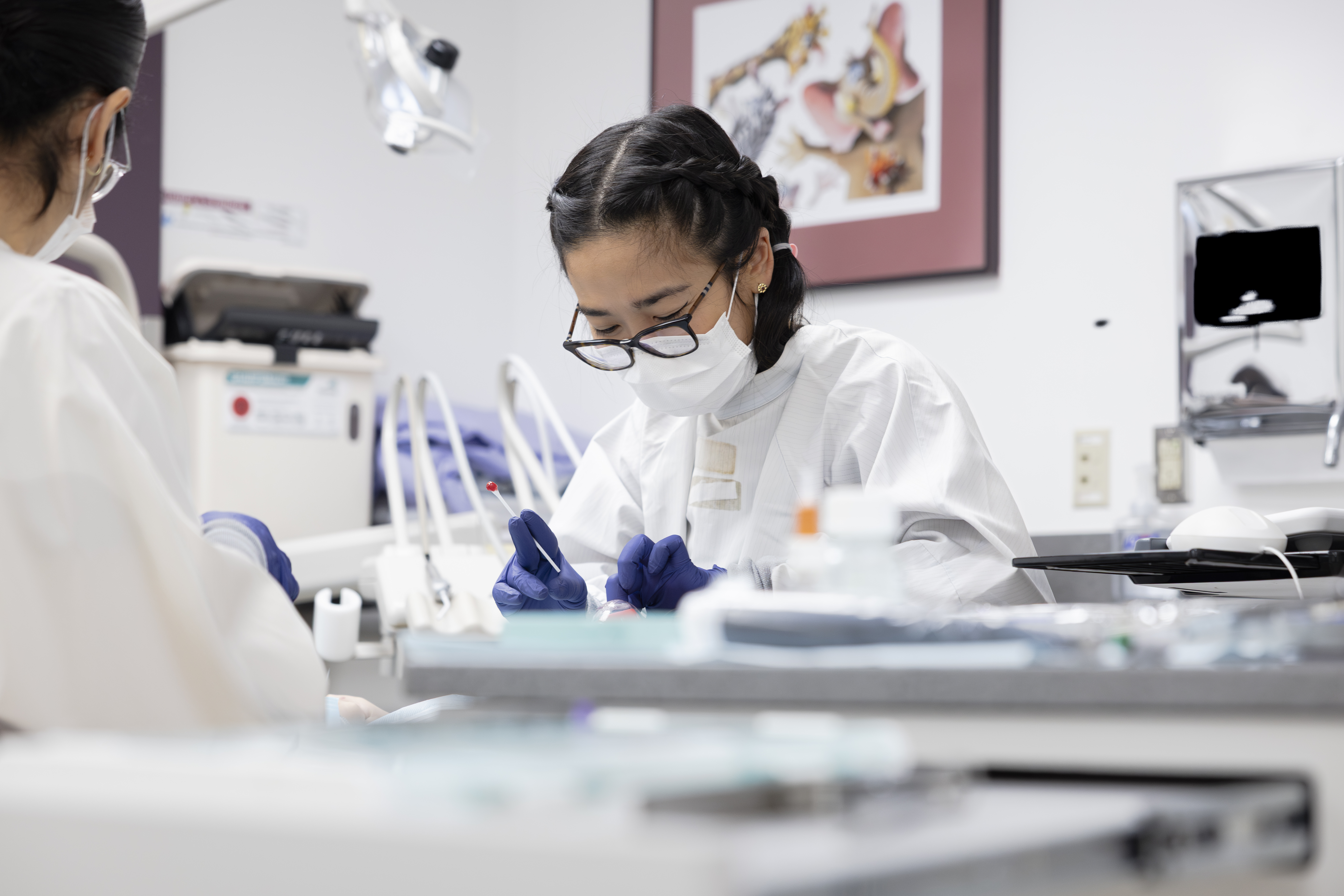 photo of resident and dental assistant working on young patient