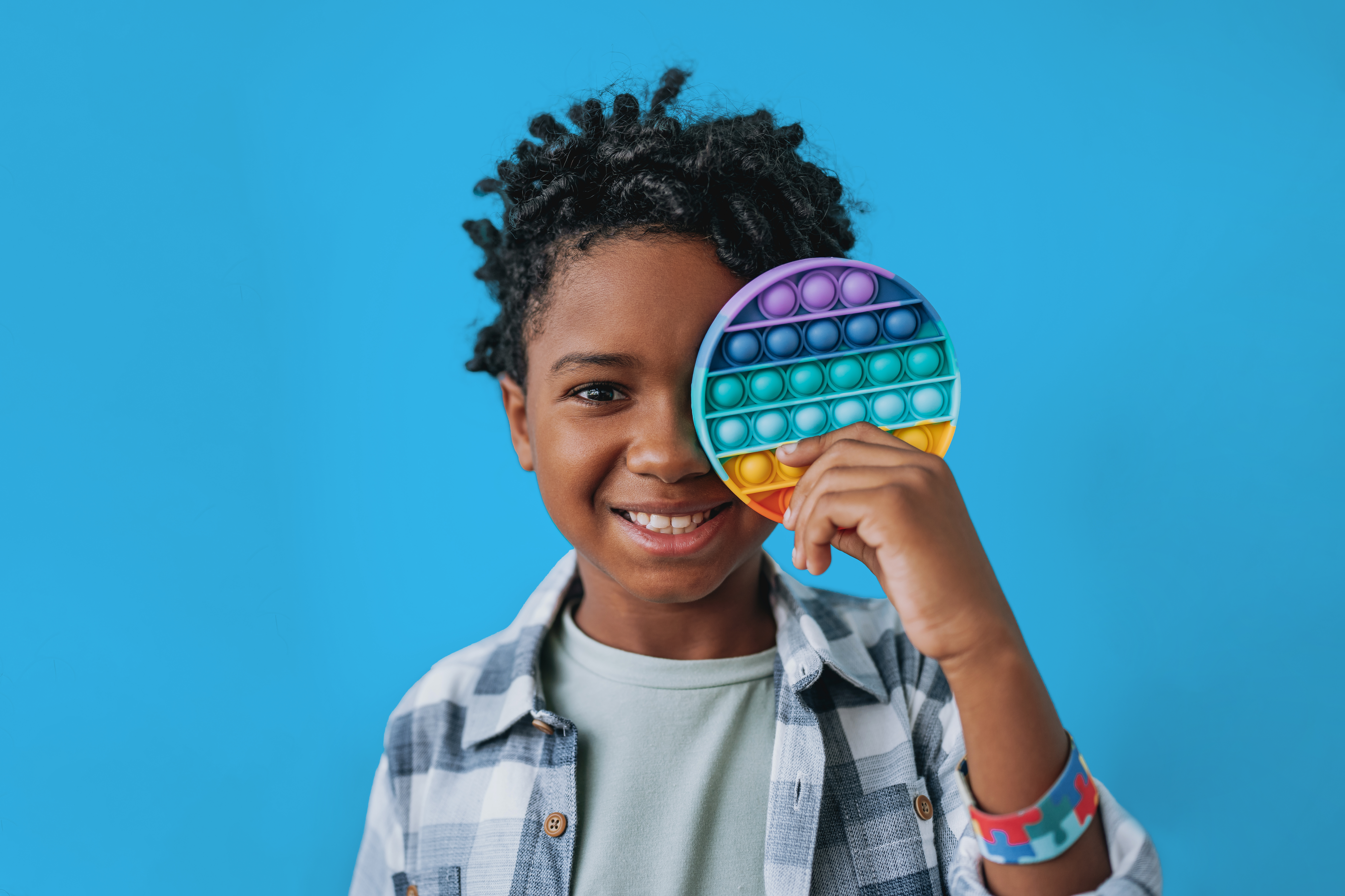 child with colorful toy in their hand