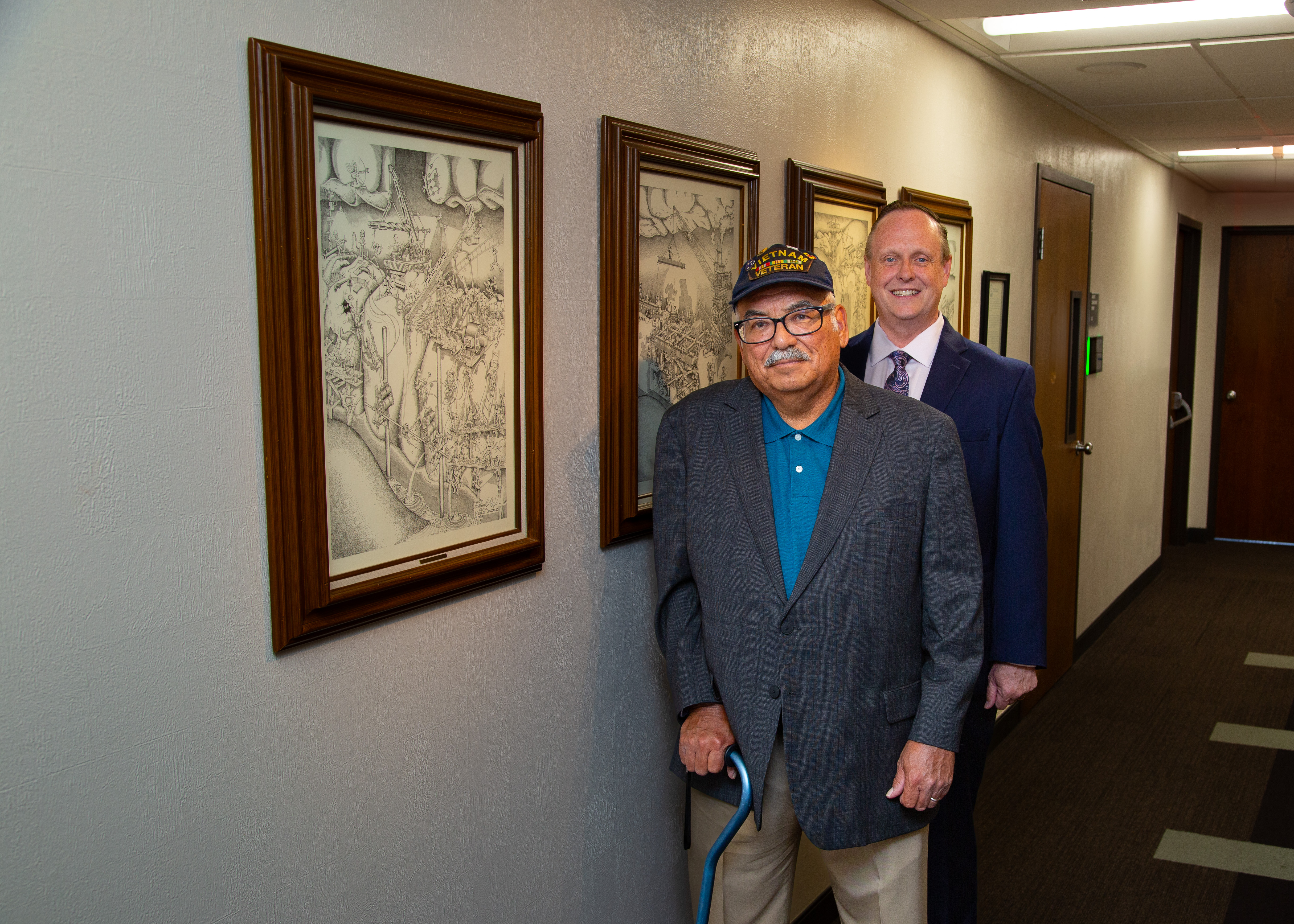 Mike Gonzales and Dean Handysides standing in Prince Hall with Lithographs