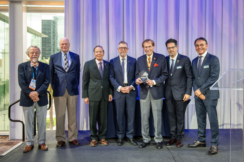 Award recipients pose on stage in Orlando.