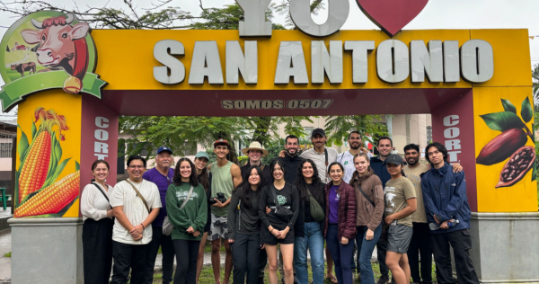 group photo near a sign that says I heart San Antonio