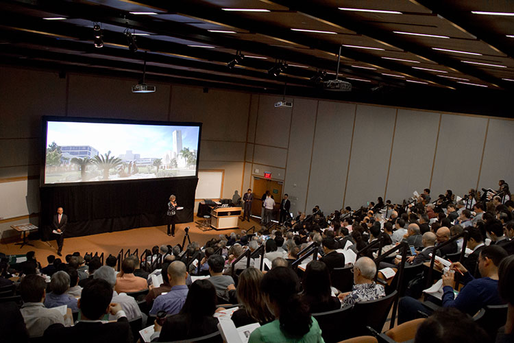 Large audience seated in an auditorium watching a presentation on implant dentistry during the 40th Anniversary Celebration..