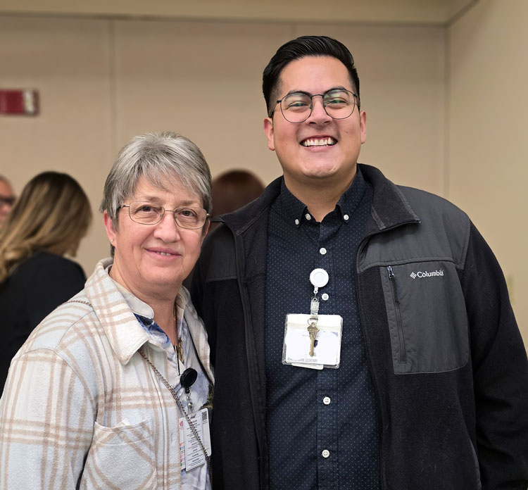 Ethan and Alisa, infection control and safety managers at Loma Linda University School of Dentistry, standing together at a campus event
