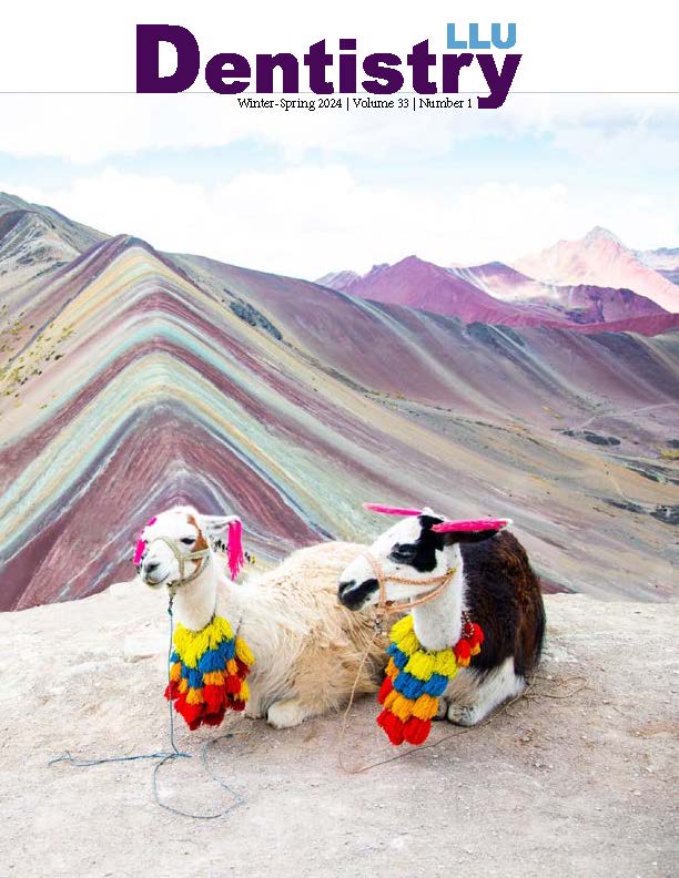 Cover of LLU Dentistry journal, Winter–Spring 2024, featuring two llamas in front of a colorful mountain landscape.