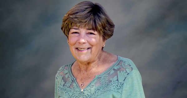 Portrait of Shirley photographed against a neutral background