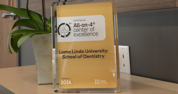 ll-on-4 Center of Excellence award displayed for Loma Linda University School of Dentistry, certified in 2024.