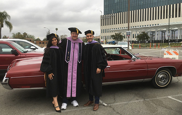 Dr. Mitchell is bracketed by Dr. Daras and Dr. Alqadoumi.