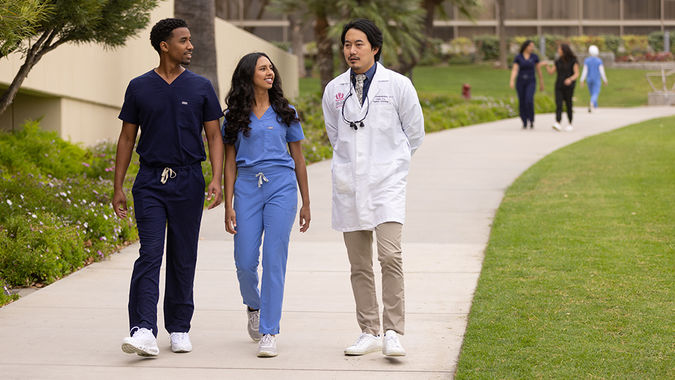 student and doctor walking on path