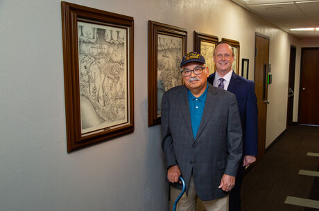 Mike Gonzales and Dean Handysides standing in Prince Hall with Lithographs