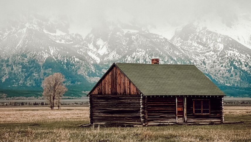 wood house surrounded by mountains
