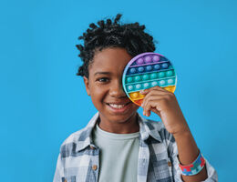 child with colorful toy in their hand