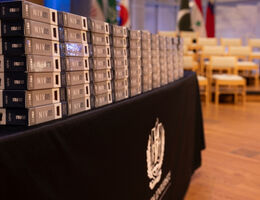 Stacked bibles displayed on a table in preparation for a School of Dentistry dedication ceremony