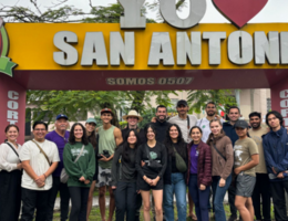 group photo near a sign that says I heart San Antonio