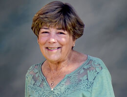 Portrait of Shirley photographed against a neutral background