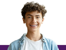 Young person wearing braces, photographed against a white background for an orthodontic dental care feature.